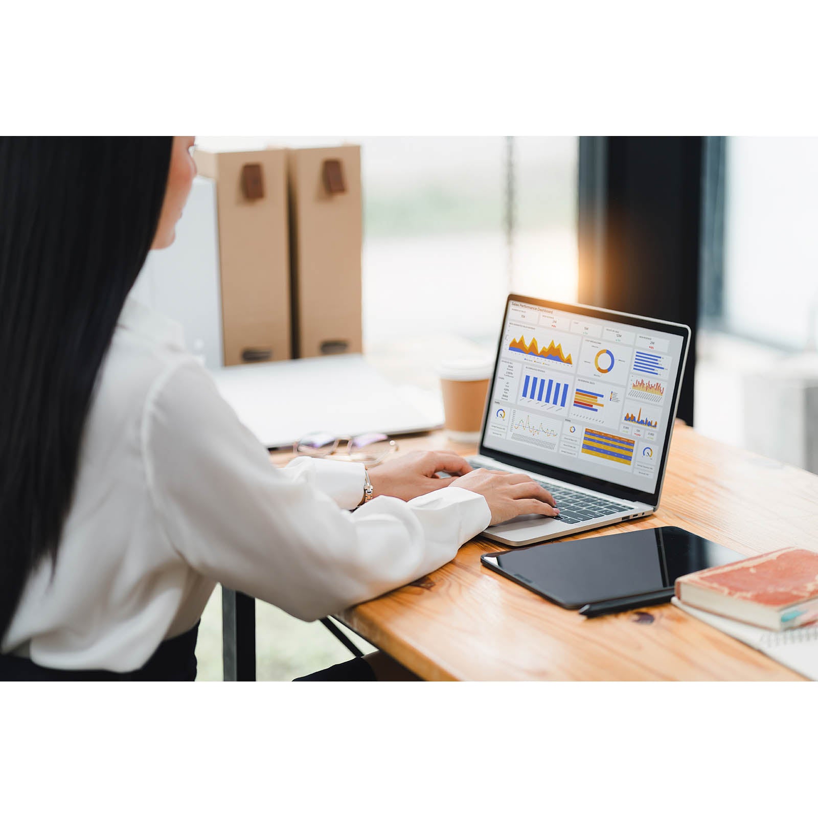 Business professional analyzing sales performance dashboard