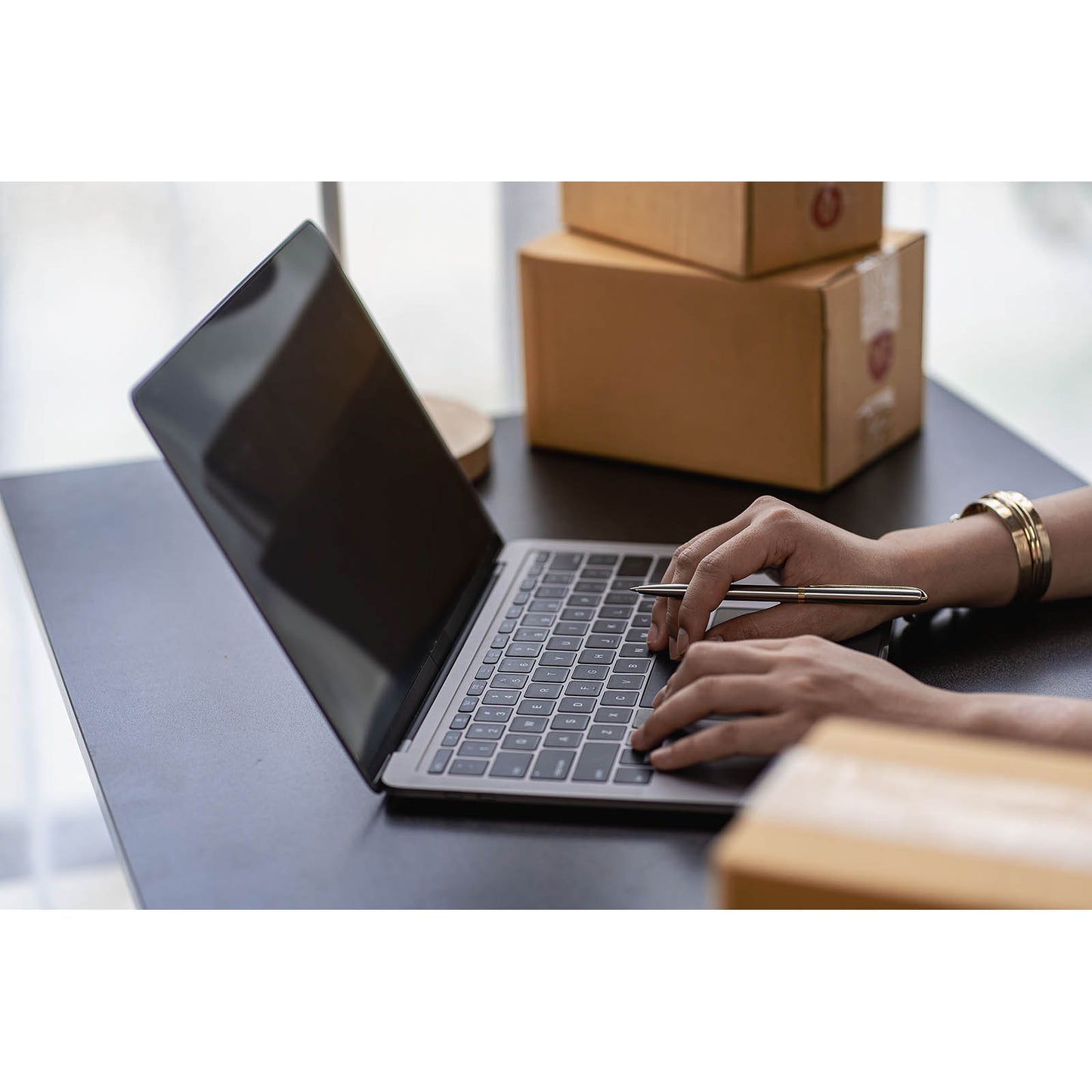 Online store owner managing orders and packing parcels